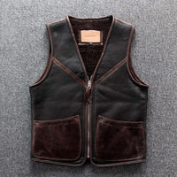 Lamb wool warm leather vest with zipper closure and patch pockets on a grey fabric background