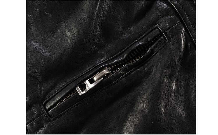 Close-up of a zipper on a men's slim-fit black goatskin leather motorcycle jacket made from genuine leather.