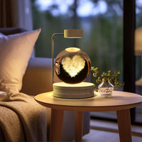 Crystal Ball Cosmic Dinosaur Indoor Night Light on bedside table, providing warm and romantic atmosphere with USB power.