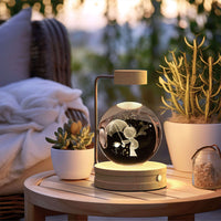 Crystal Ball Cosmic Dinosaur Indoor Night Light USB Power Warm Bedside Light Birthday Gift Night Lamp on wooden table with plants and blanket in background