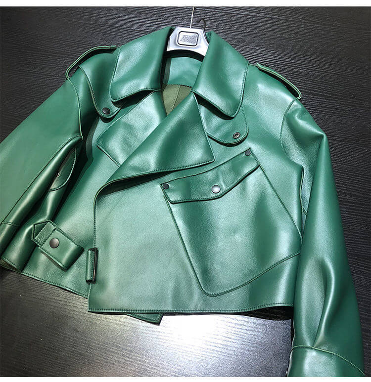 Green women's sheepskin loose biker jacket made from high-quality leather, perfect for stylish OL commuters, displayed on a table.