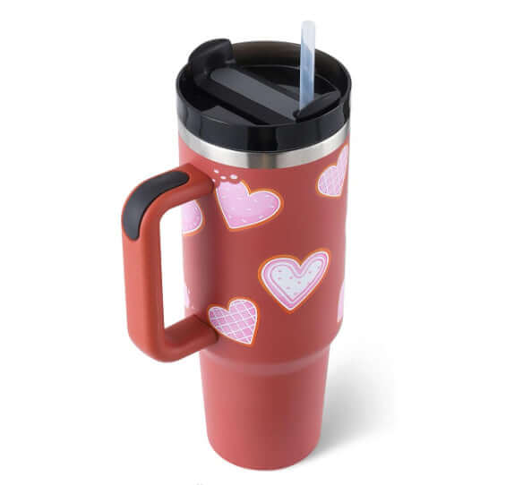 40 Oz insulated tumbler with handle and straw, featuring heart design, premium quality stainless steel for hot and cold beverages.