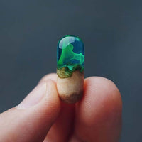 Hand holding a Handcrafted Log Resin Pendant with a real log encased in clear, green-tinted resin, showcasing nature-inspired modern design.