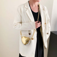 Woman wearing a white blazer with black shirt holding a Mini Love-Shape Pearls Handbag, showcasing its cute and functional design.