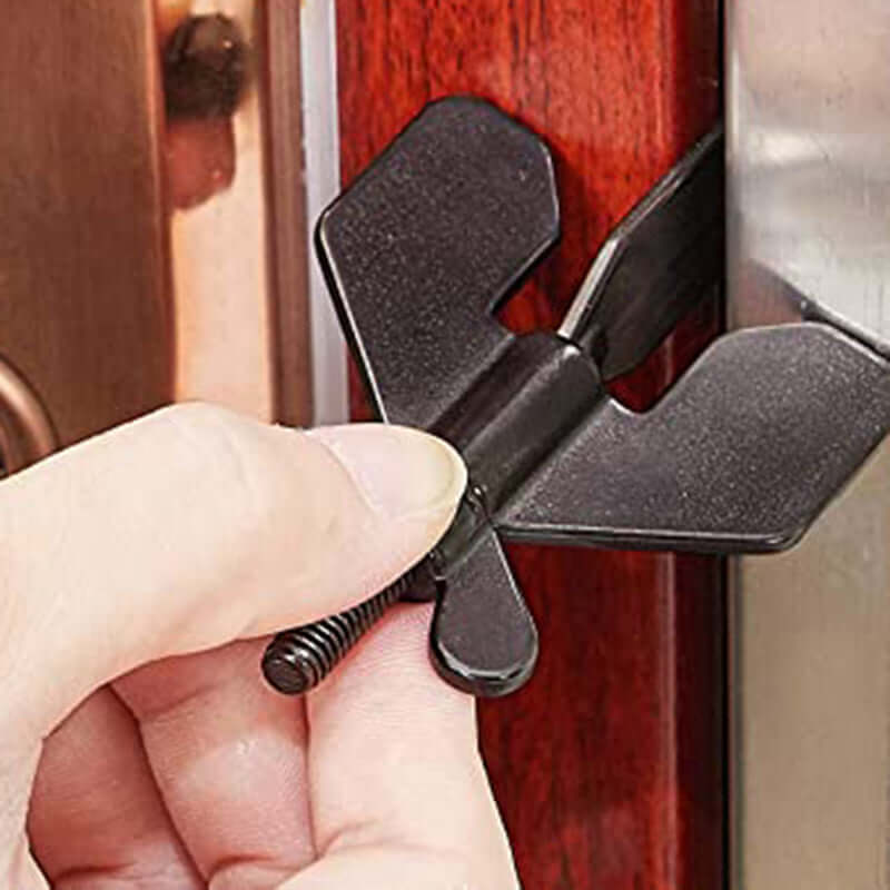 Portable hotel door lock being installed on a wooden door for self-defense and travel security.