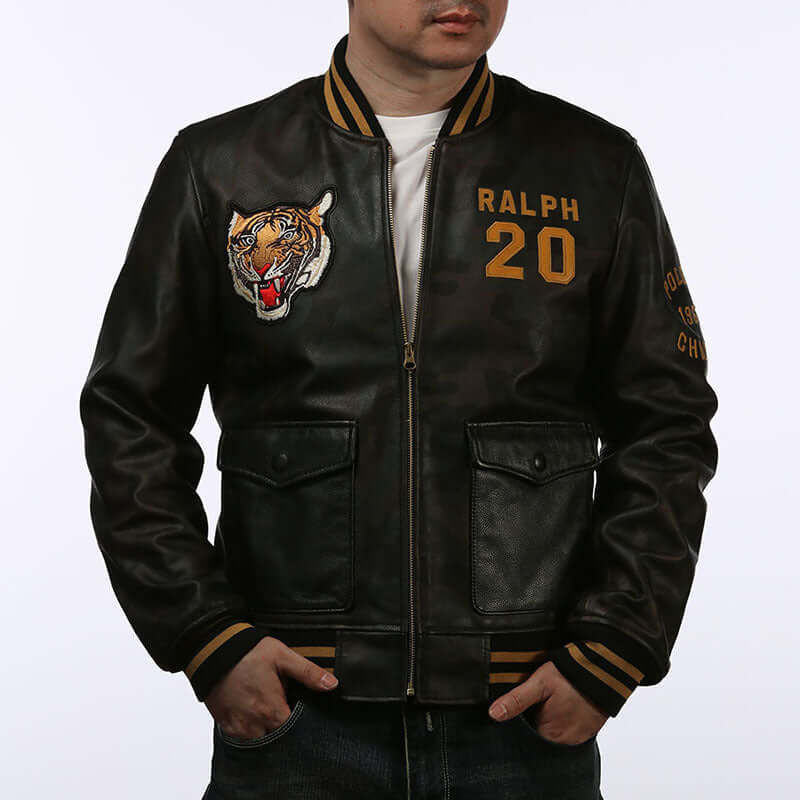 Men's casual standing collar leather baseball jacket in black with tiger embroidery and "Ralph 20" text detailing.