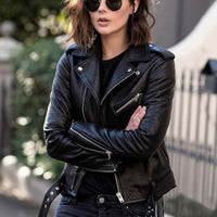 Woman in a street style outfit wearing a trendy black zip imitation leather jacket with lapel collar, perfect for adding edge.