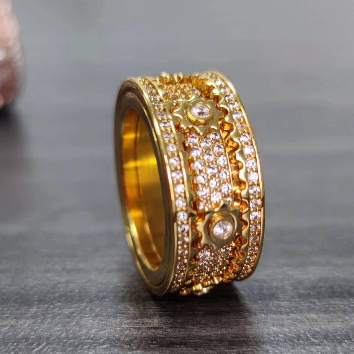 Stylish gold fidget ring with rotating band for anxiety and stress relief, adorned with sparkling crystals to improve focus.