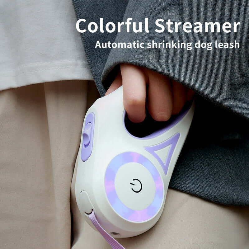 Colorful streamer retractable dog leash with automatic shrinking feature held by person