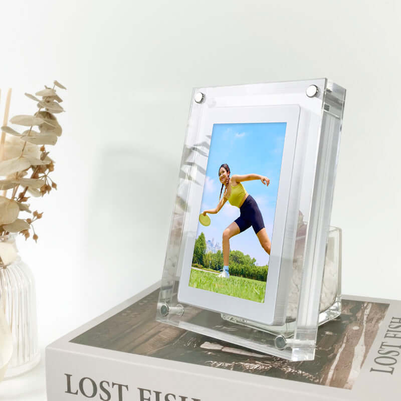 Modern acrylic digital picture frame displaying a vibrant outdoor photo on a stylish home display, showcasing a woman playing sports.