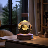 Crystal Ball Cosmic Dinosaur Indoor Night Light illuminating a cozy room. Warm bedside light on a desk, perfect for a birthday gift.