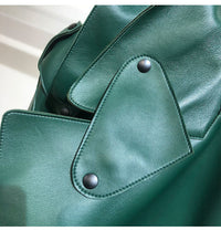 Close-up view of green female sheepskin loose biker jacket detailing with black buttons.