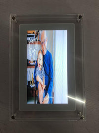 Digital picture frame displaying a heartwarming photo of a grandfather and grandchild, titled 'Happy Day'.