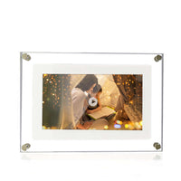 Modern digital picture frame displaying a cozy scene, perfect for showcasing memories or videos in a stylish acrylic design.