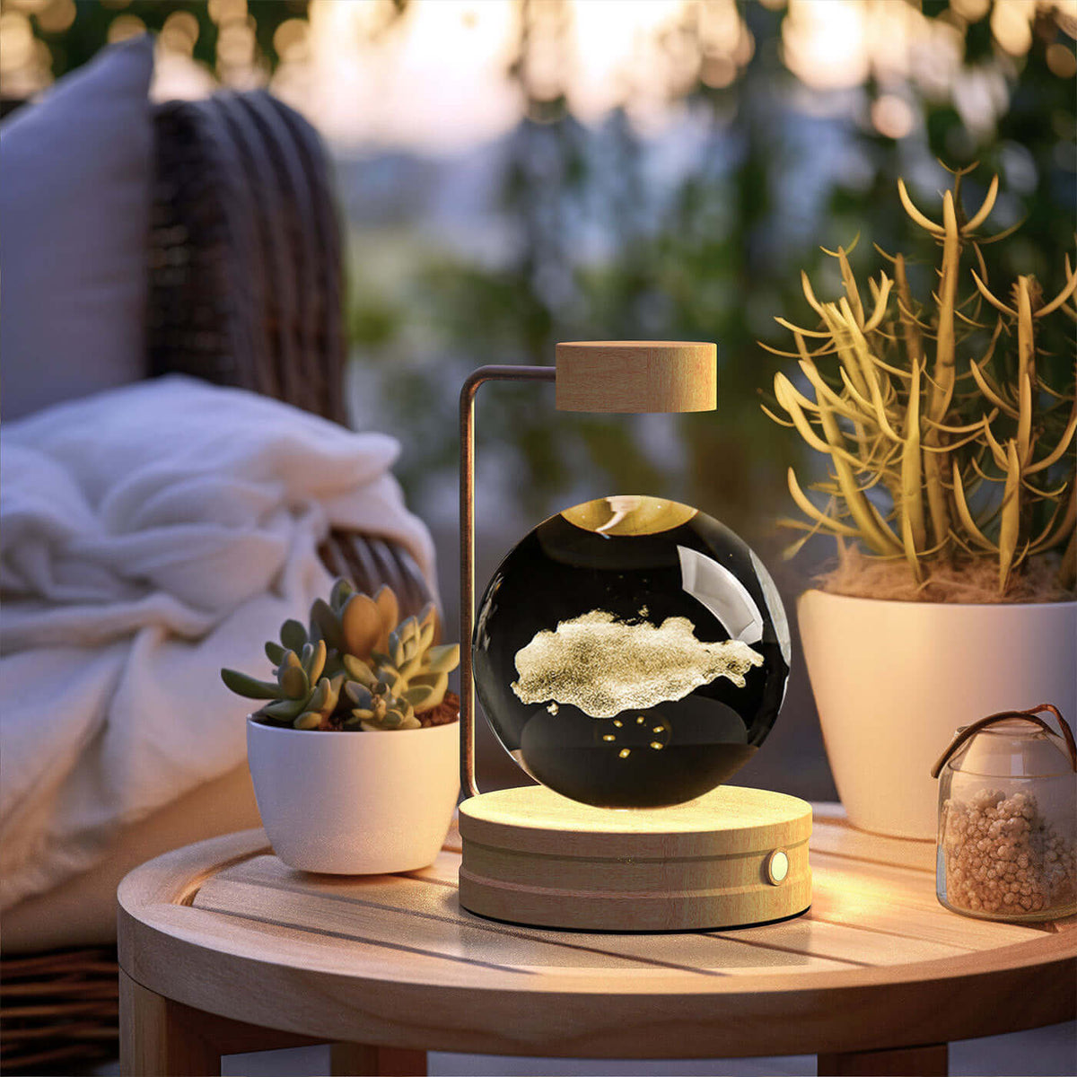 Crystal Ball Cosmic Dinosaur Indoor Night Light on a wooden table, creating a warm romantic atmosphere with succulents and cozy bedding nearby.